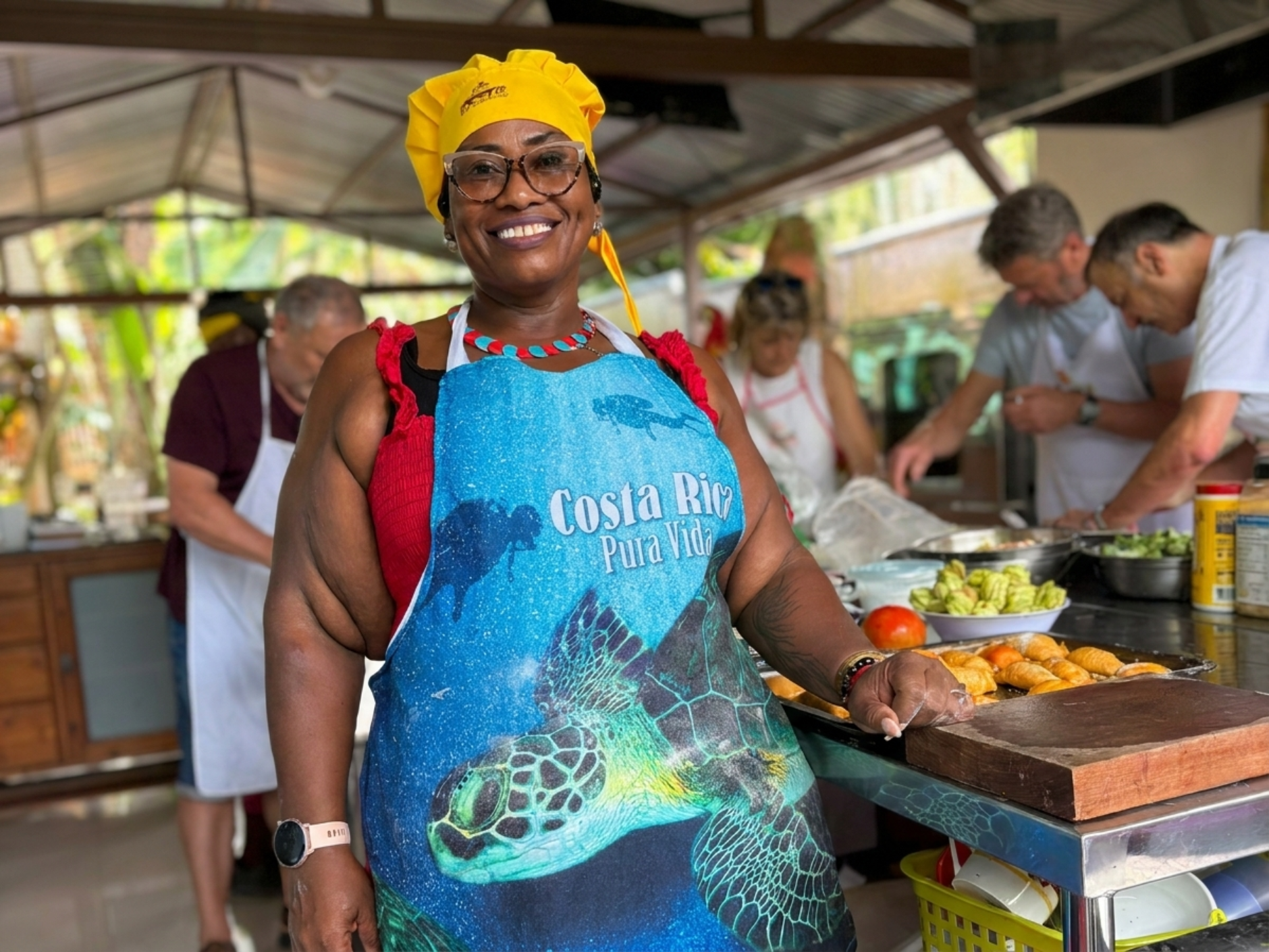 Chef Doria cooking with guests in her open-air kitchen in Cahuita, Costa Rica